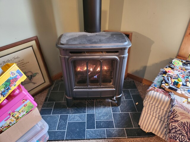 53 Village Rd, Stetson, ME 04488 - detailed view of a wood stove and baseboards