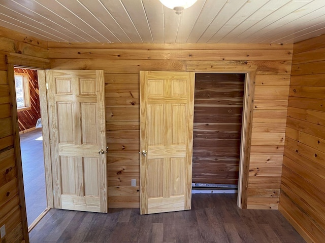 144 Redneck Rd, Starks, ME 04911 - unfurnished bedroom with dark wood finished floors, wood ceiling, and wooden walls