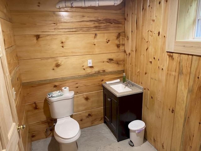 144 Redneck Rd, Starks, ME 04911 - half bathroom featuring wood walls, toilet, and vanity