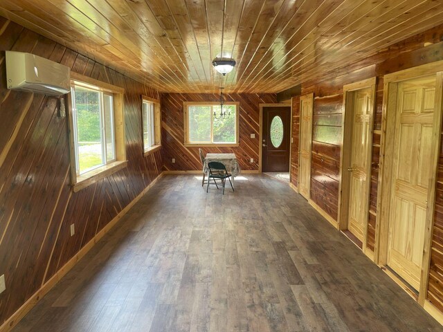 144 Redneck Rd, Starks, ME 04911 - unfurnished dining area featuring a wall unit AC, wooden ceiling, dark wood-style flooring, and wood walls