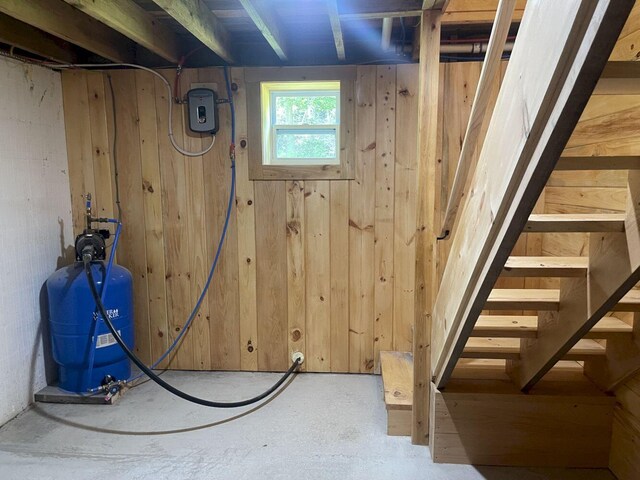 144 Redneck Rd, Starks, ME 04911 - below grade area featuring a water pressure tank, wooden walls, and stairs