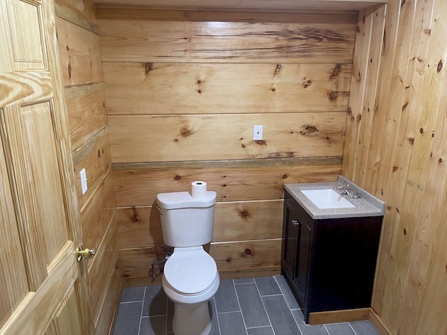 144 Redneck Rd, Starks, ME 04911 - bathroom featuring vanity, tile patterned floors, and wood walls