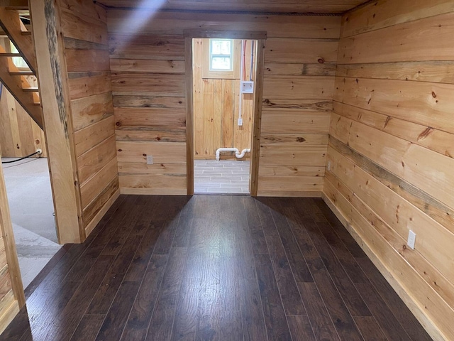 144 Redneck Rd, Starks, ME 04911 - unfurnished room featuring dark wood-type flooring, wood walls, and stairs