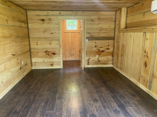144 Redneck Rd, Starks, ME 04911 - empty room with wooden walls, dark wood-style floors, wooden ceiling, and a wall unit AC