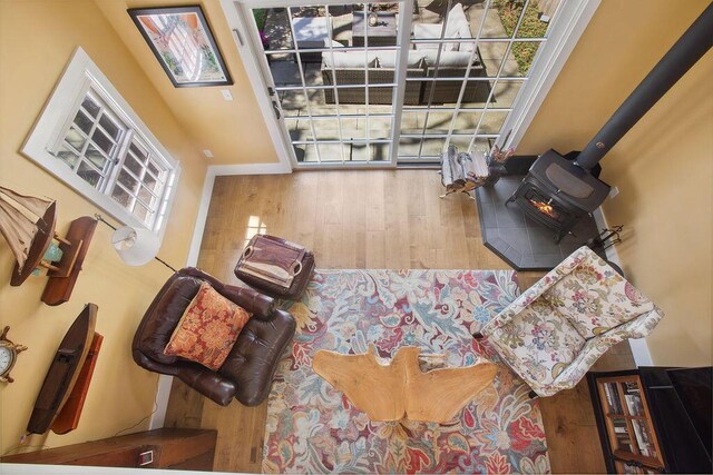 living room with wood finished floors and a wood stove