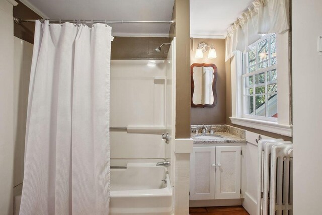 bathroom with vanity, radiator, and shower / tub combo with curtain