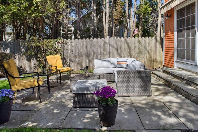 view of patio / terrace featuring a fenced backyard, entry steps, and an outdoor living space