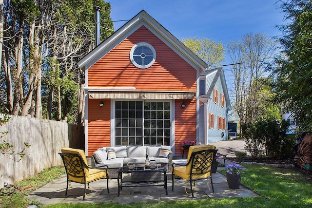 back of property with fence, a patio, and outdoor lounge area