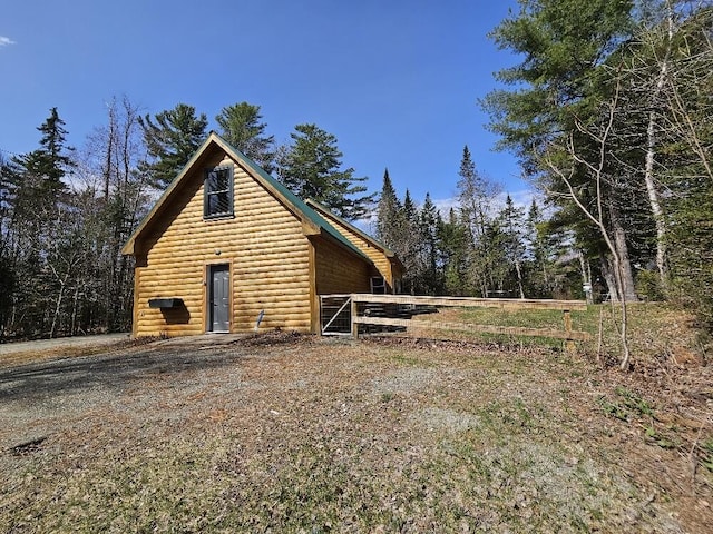 view of side of property with log veneer siding