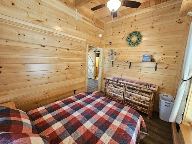 bedroom featuring beam ceiling, wooden walls, dark wood-style floors, wood ceiling, and a ceiling fan