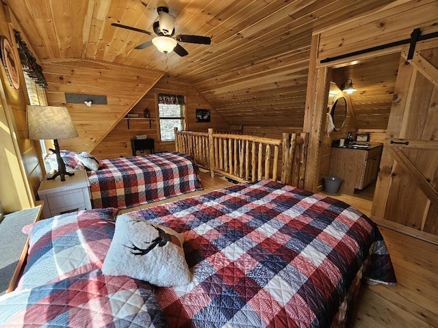bedroom with wooden walls, vaulted ceiling, wooden ceiling, and hardwood / wood-style floors