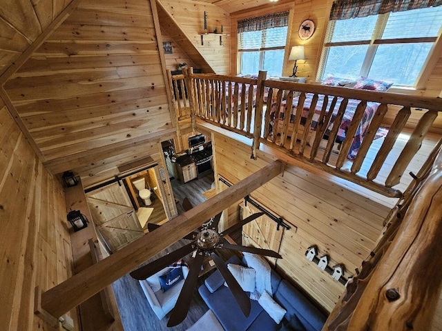 stairway featuring wood walls