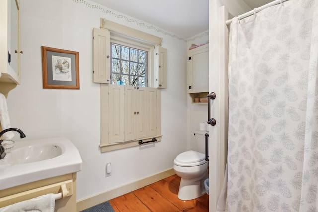 33 Smith Rd, Hallowell, ME 04347 - full bathroom featuring vanity, toilet, baseboards, curtained shower, and wood finished floors