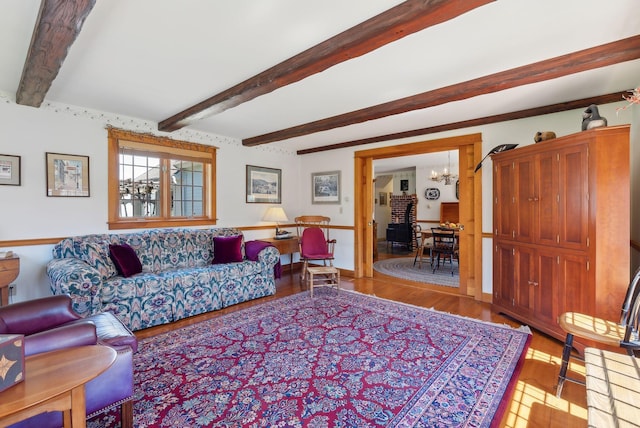 33 Smith Rd, Hallowell, ME 04347 - living room with baseboards, an inviting chandelier, beam ceiling, and light wood finished floors