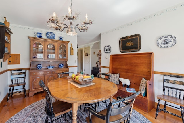 33 Smith Rd, Hallowell, ME 04347 - dining room featuring baseboards, light wood-style flooring, and a notable chandelier