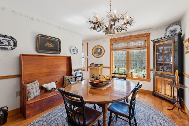 33 Smith Rd, Hallowell, ME 04347 - dining room featuring an inviting chandelier, baseboards, and light wood-type flooring