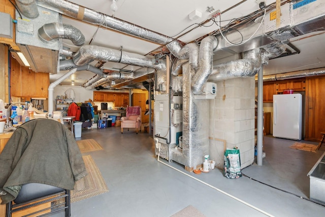 33 Smith Rd, Hallowell, ME 04347 - unfinished basement with heating unit and freestanding refrigerator