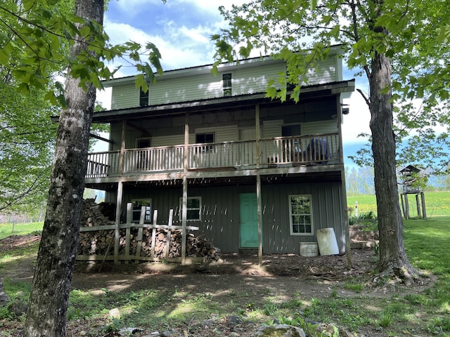 142 Palmer Rd, Thorndike, ME 04986 - back of house with board and batten siding and a wooden deck