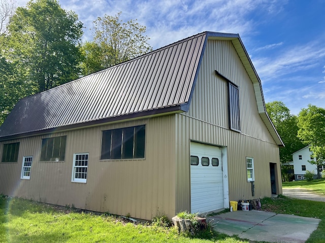 142 Palmer Rd, Thorndike, ME 04986 - view of side of property featuring a gambrel roof, a garage, a metal roof, and an outdoor structure
