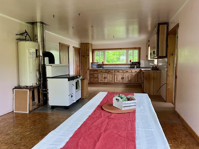 142 Palmer Rd, Thorndike, ME 04986 - kitchen with electric water heater, brown cabinets, white electric range oven, crown molding, and dark countertops