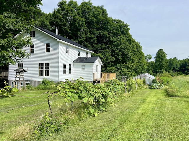 142 Palmer Rd, Thorndike, ME 04986 - back of house with a yard, a wooden deck, an outbuilding, and an exterior structure
