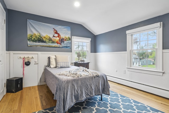 13 Juniper Ln, Cape Elizabeth, ME 04107 - bedroom featuring baseboard heating, wood finished floors, vaulted ceiling, and wainscoting