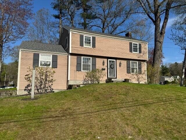 13 Juniper Ln, Cape Elizabeth, ME 04107 - colonial inspired home featuring a front yard and a chimney