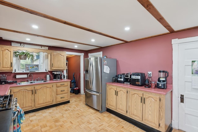 kitchen featuring a sink, light countertops, light brown cabinets, stainless steel appliances, and recessed lighting