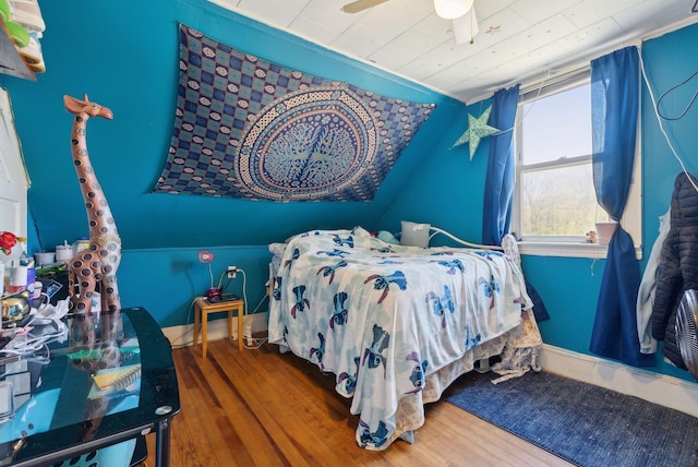 bedroom with wooden ceiling and wood finished floors