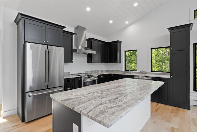 676 Sebago Rd, Sebago, ME 04029 - kitchen featuring wall chimney range hood, dark cabinets, stainless steel appliances, and recessed lighting