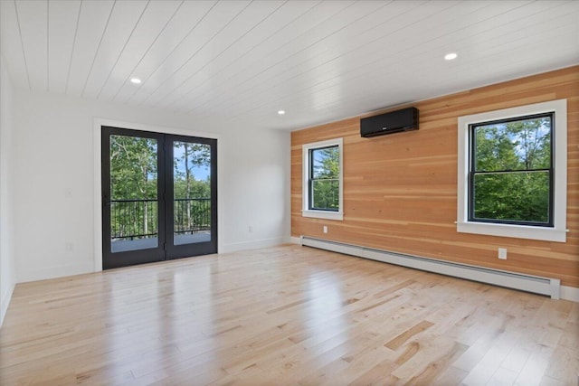 676 Sebago Rd, Sebago, ME 04029 - empty room featuring a baseboard radiator, wood finished floors, a wealth of natural light, and wood walls