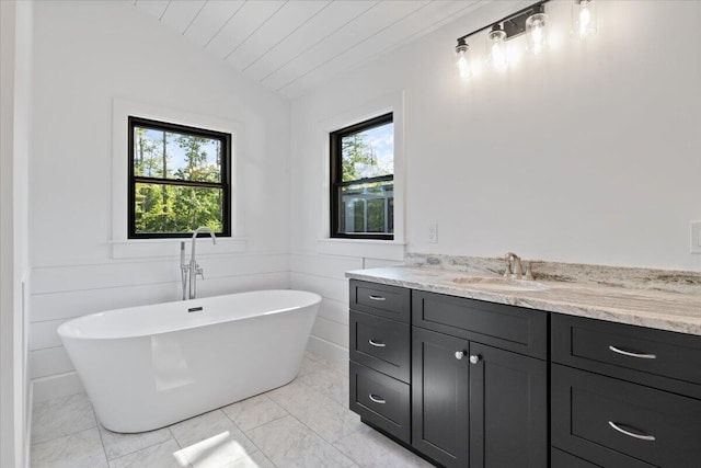 676 Sebago Rd, Sebago, ME 04029 - bathroom featuring a freestanding tub, vaulted ceiling, wooden ceiling, and vanity
