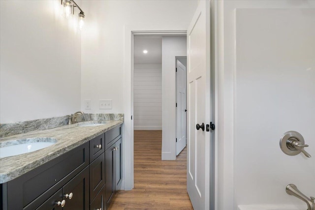 676 Sebago Rd, Sebago, ME 04029 - full bath featuring a sink, double vanity, and wood finished floors
