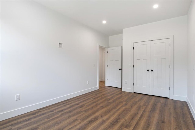 676 Sebago Rd, Sebago, ME 04029 - unfurnished bedroom with baseboards, recessed lighting, dark wood finished floors, and a closet