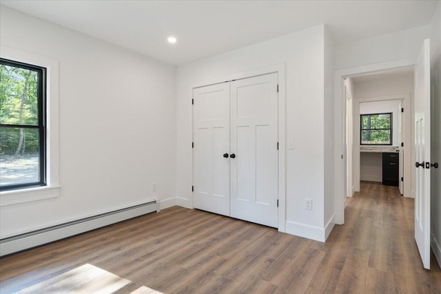 676 Sebago Rd, Sebago, ME 04029 - unfurnished bedroom featuring recessed lighting, a baseboard radiator, baseboards, and wood finished floors