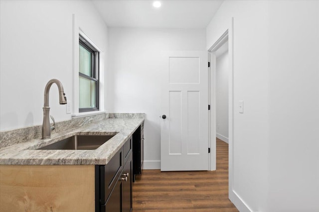 676 Sebago Rd, Sebago, ME 04029 - kitchen with light stone counters, a sink, recessed lighting, baseboards, and dark wood-style floors