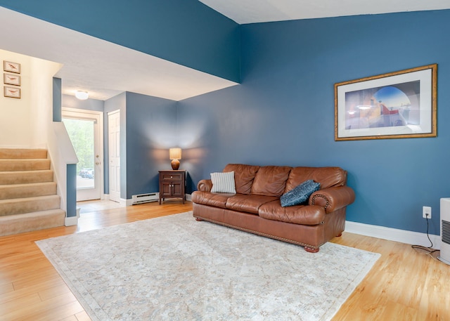 135 Portland Ave Unit 803, Old Orchard Beach, ME 04064 - living room featuring a baseboard heating unit, stairs, wood finished floors, and baseboards