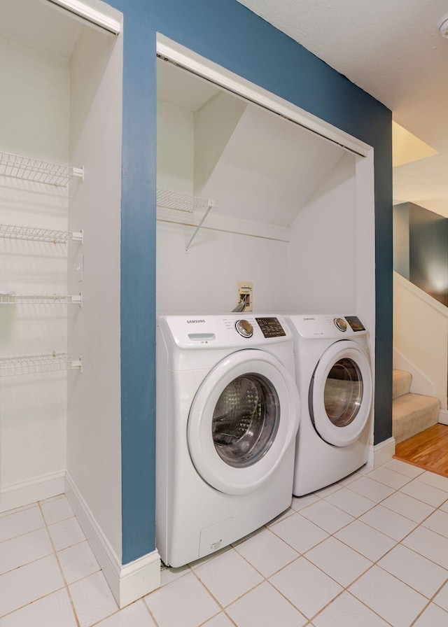 135 Portland Ave Unit 803, Old Orchard Beach, ME 04064 - laundry area with washer and clothes dryer, tile patterned floors, and baseboards