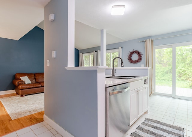 135 Portland Ave Unit 803, Old Orchard Beach, ME 04064 - kitchen featuring dishwasher, a sink, vaulted ceiling, light countertops, and baseboards
