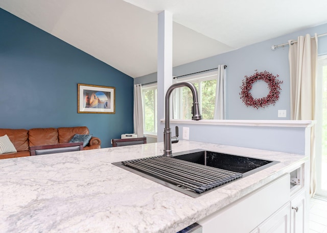 135 Portland Ave Unit 803, Old Orchard Beach, ME 04064 - kitchen featuring a sink, vaulted ceiling, light stone counters, and white cabinets