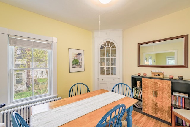 8 Park St, Camden, ME 04843 - dining space with wood finished floors, plenty of natural light, and radiator heating unit