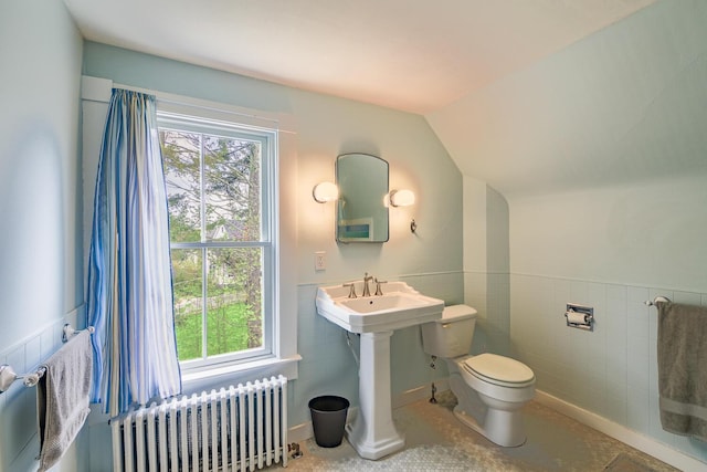 8 Park St, Camden, ME 04843 - bathroom featuring radiator heating unit, toilet, healthy amount of natural light, lofted ceiling, and tile walls
