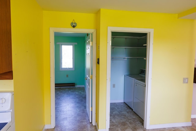 laundry room with a baseboard radiator, washing machine and dryer, and baseboards