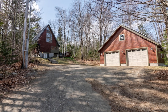 view of home's exterior with a garage and an outdoor structure