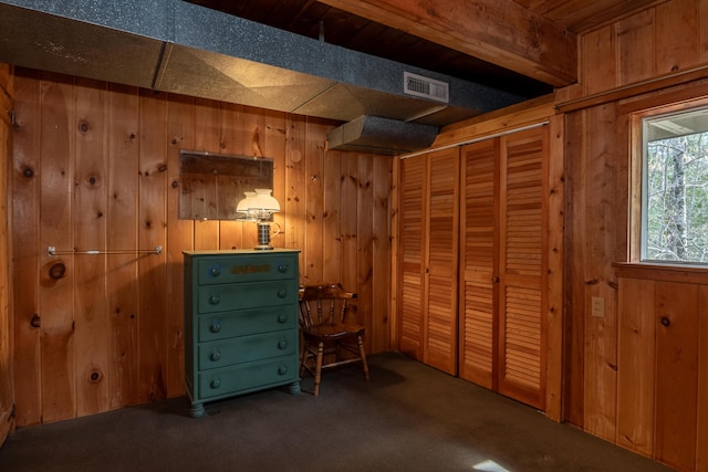 miscellaneous room featuring visible vents, wood walls, and carpet