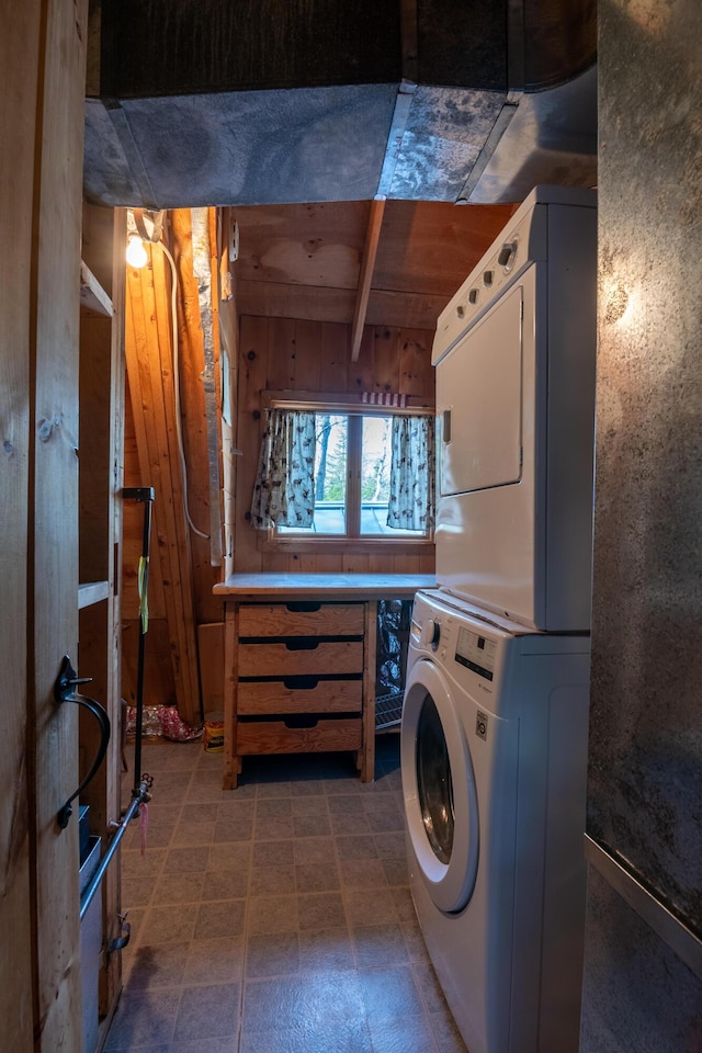 laundry room featuring laundry area and stacked washer / drying machine