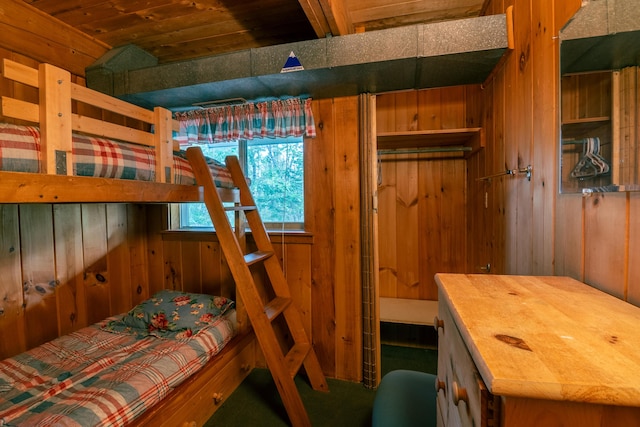 bedroom featuring wooden walls and wooden ceiling