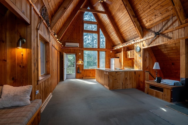 unfurnished living room featuring a wall mounted air conditioner, wood ceiling, a ceiling fan, and wooden walls
