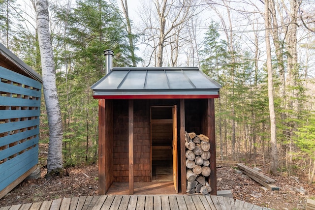 view of shed with a view of trees