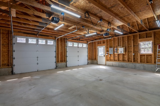 garage featuring a garage door opener and electric panel